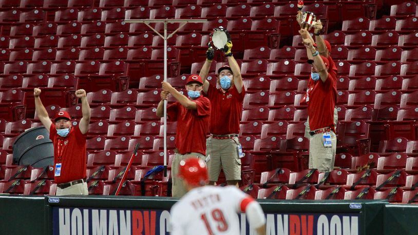 Joey Votto, of the Reds, rounds first base after a home run in the sixth inning against the Indians as the grounds crew cheers on Monday, Aug. 3, 2020, at Great American Ball Park in Cincinnati. David Jablonski/Staff