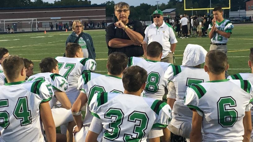 New Miami coach John Singleton talks to his team after the Vikings dropped a 20-6 decision to Gamble Montessori on Aug. 26 at Woodward. RICK CASSANO/STAFF
