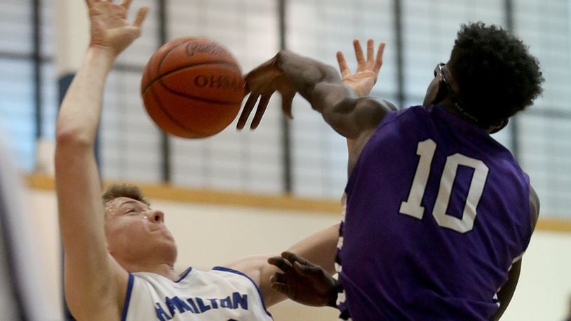 Middletown’s Jomar Bailey goes for a block against Hamilton forward Hunter Hamilton during their game at the Hamilton Athletic Center on Feb. 12. CONTRIBUTED PHOTO BY E.L. HUBBARD