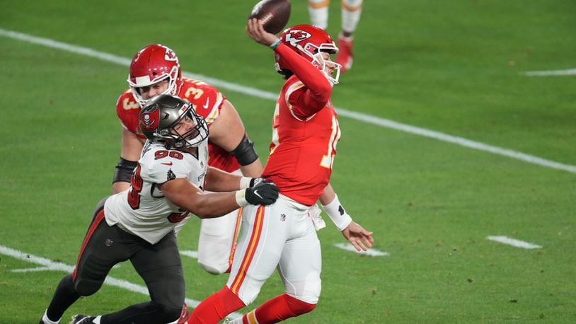 Kansas City Chiefs quarterback Patrick Mahomes (15) tries to pass as Tampa Bay Buccaneers outside linebacker Anthony Nelson (98) grabs him from behind in the second quarter of Super Bowl LV at Raymond James Stadium in Tampa, Fla., Feb. 7, 2021. (Chang W. Lee/The New York Times)