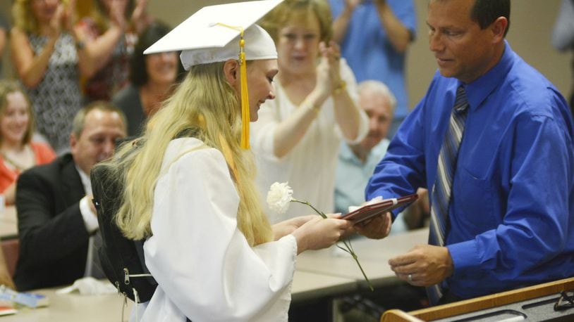 Elizabeth Schulze receives her diploma from Fairfield High School Principal Billy Smith during a special graduation ceremony Friday afternoon at the Fairfield High School’s community room. The graduated senior missed out on graduating with her classmates on May 28 at the Cintas Center due to an illness. She has Ehlers-Danlos syndrome, an inherited genetic disorder that affect a person’s connective tissues.