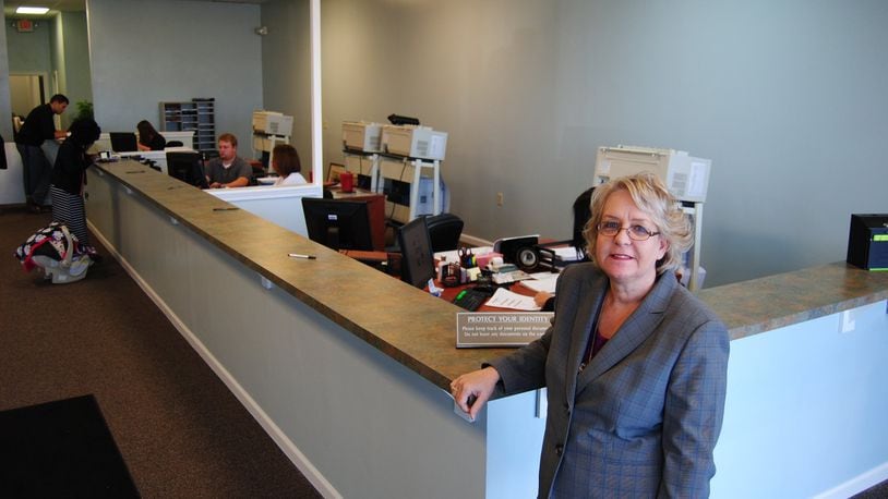 Butler County Clerk of Courts Mary Swain stands at the counter of the new Title Division office at 4872 Union Centre Pavilion Drive in West Chester Twp. on Monday, Oct. 27, 2014. The office, which processes vehicle titles, watercraft titles and passports applications, outgrew years ago the location that had operated on Smith Road. ERIC SCHWARTZBERG / STAFF