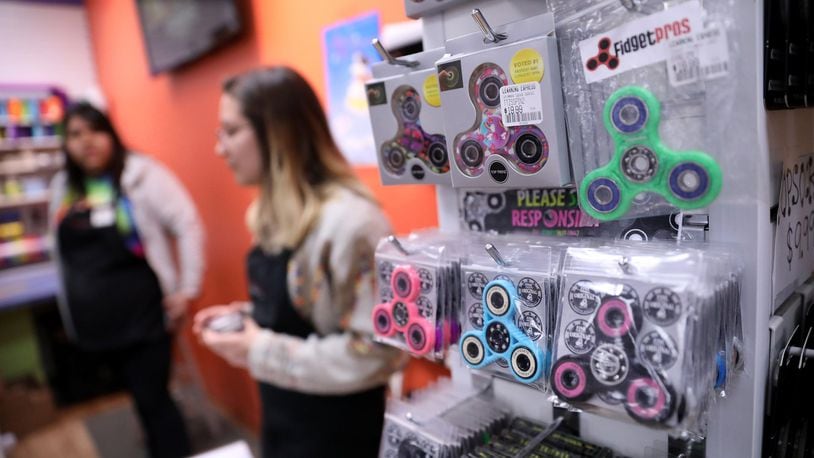 Employees help people shopping for spinner fidget toys on Thursday, April 27, 2017 at Learning Express in suburban Clarendon Hills, Ill. (Chris Sweda/Chicago Tribune/TNS)