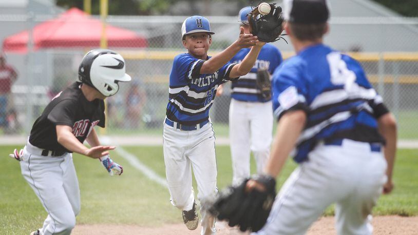 Hamilton West Side’s Braedyn Moore catches a rundown throw from teammate Davis Avery (4) as Canfield’s Connor Daggett tries to escape during an Ohio Little League 12-year-old baseball tournament game July 20 at Ford Park’s Robert S. Hoag Field in Maumee. CONTRIBUTED PHOTO BY SCOTT GRAU