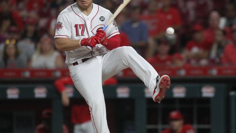 The Reds’ Josh VanMeter is hit by a pitch against the Astros on Tuesday, June 18, 2019, at Great American Ball Park in Cincinnati. David Jablonski/Staff