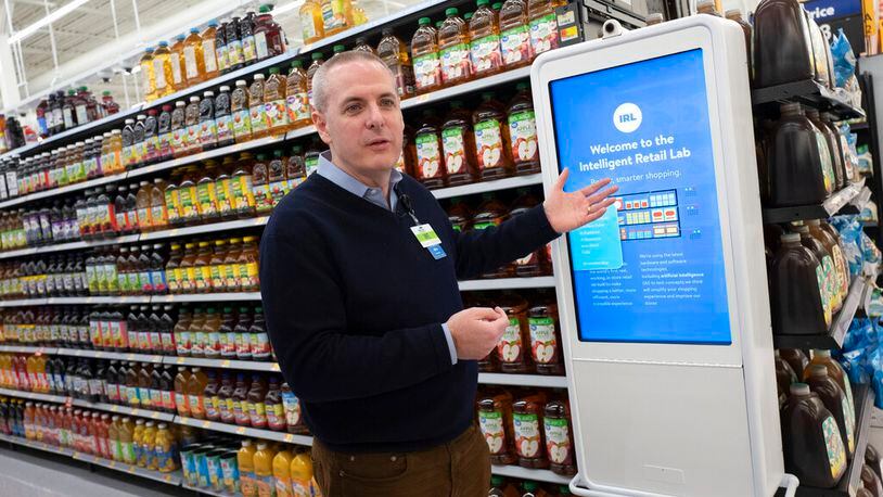 Mike Hanrahan, CEO of Walmart's Intelligent Retail Lab, discusses a kiosk that describes to customers the high technology in use at a Walmart Neighborhood Market, Wednesday, April 24, 2019, in Levittown, N.Y. "If we know in real time everything that's happening in the store from an inventory and in stock perspective, that really helps us rethink about how we can potentially manage the store," said Hanrahan.