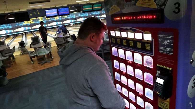 FILE PHOTO: Brandon Oty looks over the Ohio Lottery instant games in a kiosk at Victory Lanes bowling alley in Springfield. BILL LACKEY/STAFF
