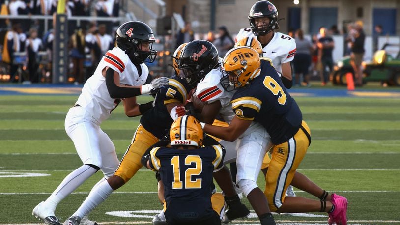 Springfield tackles Beavercreek's Quentin Youngblood on Friday, Sept. 15, 2023, in Springfield. David Jablonski/Staff