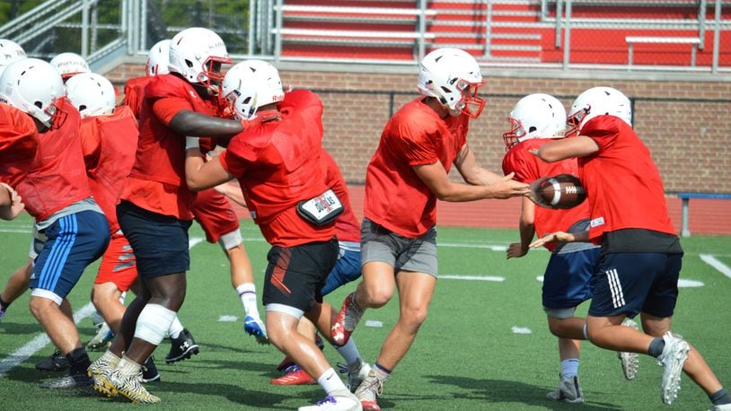 Talawanda Quarterback Braden Wright hands off the ball in practice Aug. 11, 2020 during an offensive drill. CONTRIBUTED/BOB RATTERMAN