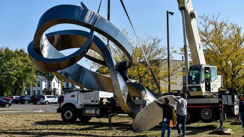The 25-foot-tall ‘Embrace’ sculpture was delivered and installed at the intersection of Main Street, Millville Avenue and Eaton Avenue Wednesday, October 7, 2020 in Hamilton. The sculture was created in Arkansas and was hauled by truck to Hamilton. NICK GRAHAM /STAFF