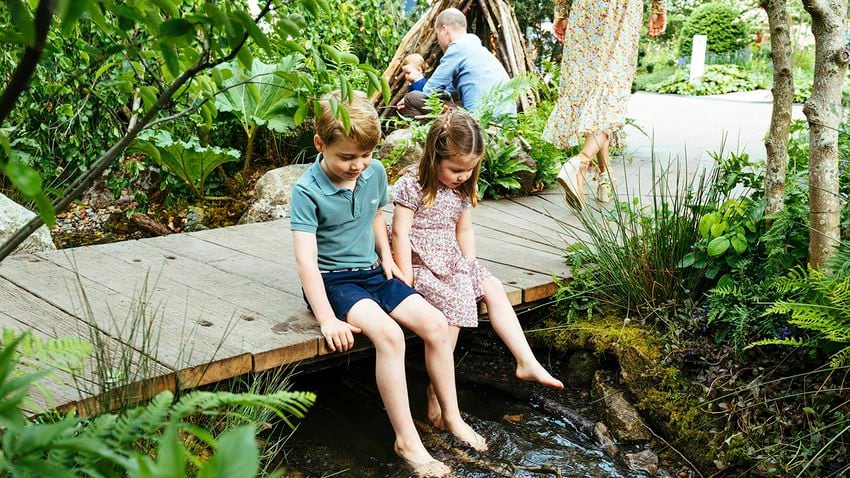 In this image made available on Sunday May 19, 2019 by Kensington Palace, Britain's Kate, Duchess of Cambridge and her son Prince Louis play in the ‘Bback to Nature’ garden at the RHS Chelsea Flower Show in London