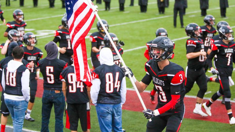 Franklin wide receiver Kyle Rickard (3) waves the U.S. flag as the team takes the field to play Edgewood at Atrium Stadium in Franklin Community Park, Friday, Sept. 1, 2017. GREG LYNCH / STAFF