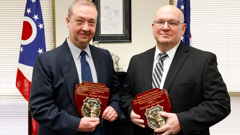 Middletown Division of Police detectives Tom McIntosh, left, and Jon Hoover were awarded the Butler County Prosecutor's 5th Annual Meritorious Service Award in recognition of their outstanding police work for the case involving the death of 6-year-old James Robert Hutchinson of Middletown. NICK GRAHAM / STAFF