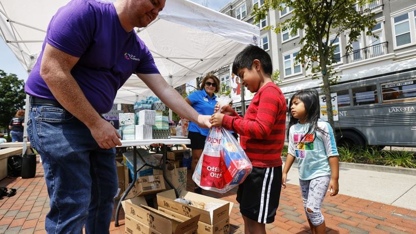 Last year saw a large turnout for the annual "Stuff The Bus" donation campaign at Liberty Center and Lakota and Cincinnati Children's officials hope for even more help this month with the campaign to get school supplies to the children of needy families. NICK GRAHAM/FILE PHOTO