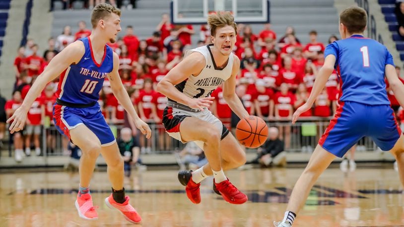 Preble Shawnee's Mason Shrout drives past Tri-Village's Tanner Printz (10) and Trey Sagester during their game on Wednesday night at Trent Arena in Kettering. Preble Shawnee won 57-48. Michael Cooper/CONTRIBUTED