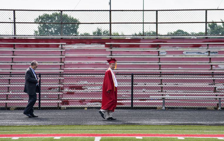 Fairfield seniors walk on the football field to get diplomas