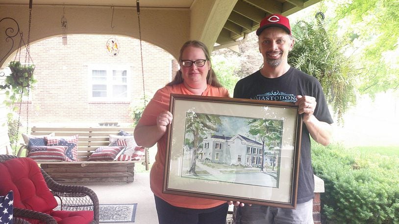 Jamie and Andy Seibert, who live on Yankee Road in Middletown, were presented a framed picture of their house that William “Bill” Rehse painted years ago. SUBMITTED PHOTO