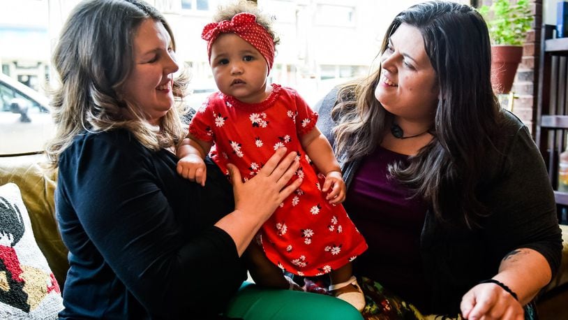 Diana Arnold, left, and Melissa Kutzera hold their daughter Leona, 1. Diana and Melissa have been married nearly five years and their adoption of Leona was final in April of this year. NICK GRAHAM / STAFF