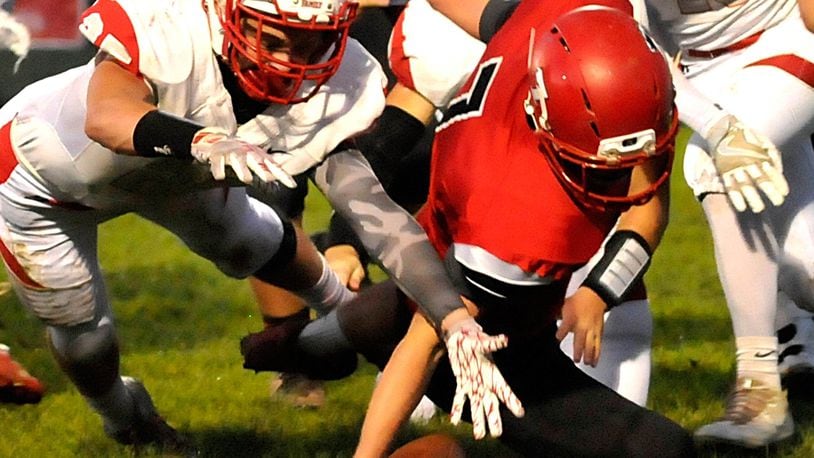 Madison quarterback Mason Whiteman (7) recovers his own fumble during the second quarter of a Southwestern Buckeye League game against Carlisle on Oct. 7, 2016, in Madison Township. The visiting Indians won 21-19. CONTRIBUTED PHOTO BY DAVID A. MOODIE