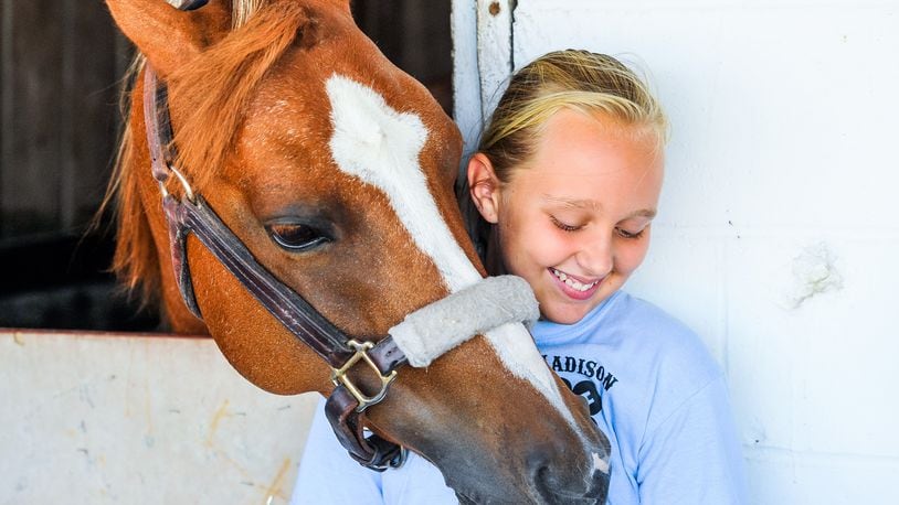 Lyla Comer, 10, with Madison Outlaws 4-H club stands with her horse, Annie, during the Butler County Fair Thursday, July 26 at the Butler County Fairgrounds in Hamilton. NICK GRAHAM/STAFF