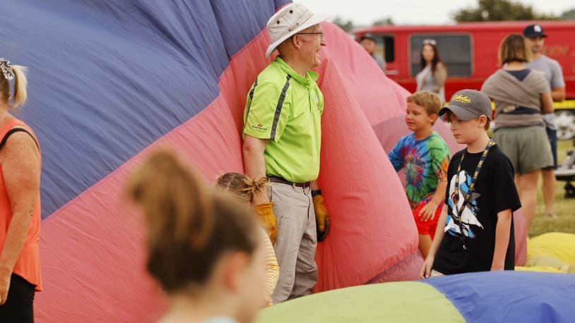 Dr. Mark Frazier inflated his balloon, Release, on Friday, opening night of the Ohio Challenge hot air balloon festival at Smith Park. Frazier, a lifetime Middletown resident, encouraged city leaders to end the lawsuits with a local business. NICK GRAHAM/STAFF
