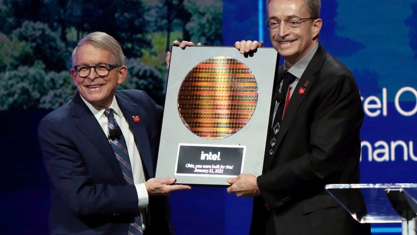 FILE - Intel CEO Patrick Gelsinger, right, presents Ohio Gov. Mike DeWine with a silicon wafer during on Jan. 21, 2022 in Newark, Ohio, where Intel announced it will invest $20 billion to build two computer chip factories on a 1,000-acre site in Licking County, Ohio, just east of Columbus. Intel said Thursday it will invest $50 million in Ohio higher education initiatives targeting the semiconductor industry, and partner with the U.S. National Science Foundation which is providing an additional $50 million for research grants nationally.  (AP Photo/Paul Vernon, File)