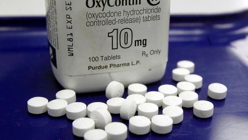 OxyContin pills are arranged for a photo at a pharmacy. Teva, Allergen, CVS, Walgreens and Walmart are all involved in a nationwide settlement agreement in which they are accused of reckless practice that exacerbated the opioid epidemic. FILE