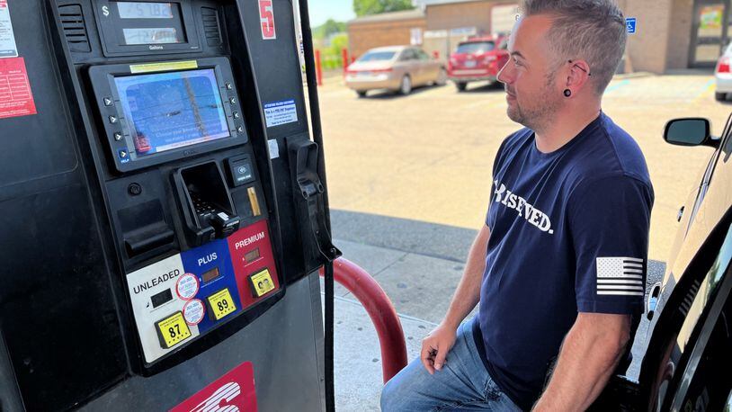 Dustin Shepherd, 36, of Miamisburg, fills up at a Speedway gas station in Dayton on Friday. Regular unleaded gas cost $4.79 at some local stations. CORNELIUS FROLIK / STAFF