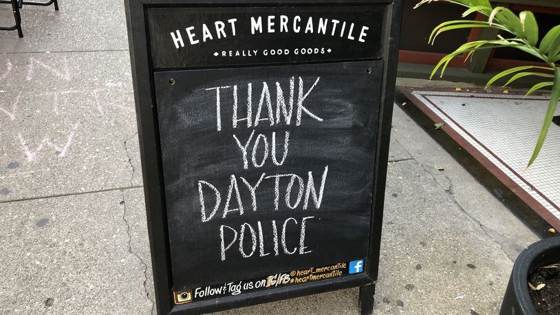 Signs were posted all over the city thanking Dayton police after the Aug. 4 mass shooting in the Oregon District. CORNELIUS FROLIK / STAFF