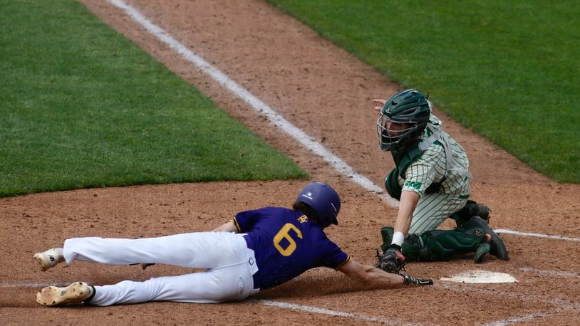Badin catcher Jimmy Nugent tags out Bloom-Carroll's Evan Dozer at home plate in a Division II state semifinal on Friday, June 11, 2021, at Canal Park in Akron. David Jablonski/Staff