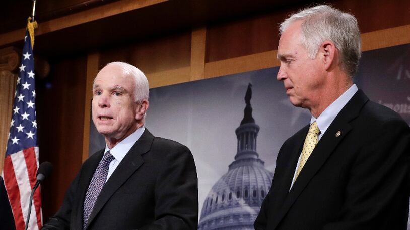 FILE - In this July 27, 2017 file photo, Sen. Ron Johnson, R-Wis. listens as Sen. John McCain, R-Ariz. speaks on Capitol Hill in Washington. (AP Photo/J. Scott Applewhite)