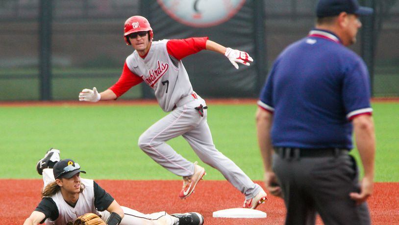 Lakota West’s Bryce Johnson (7) heads for third after a wild throw to Centerville infielder Jared Lieberman (13) during a Division I regional semifinal held at the University of Cincinnati’s Marge Schott Stadium on May 25. GREG LYNCH/STAFF