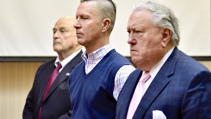 Butler County business man Jeff Couch, center, with attorney R. Scott Croswell III, right, was arraigned today in Butler County Common Pleas Court for felonious assault and domestic violence for an alleged assault at their West Chester Twp. home. NICK GRAHAM/STAFF