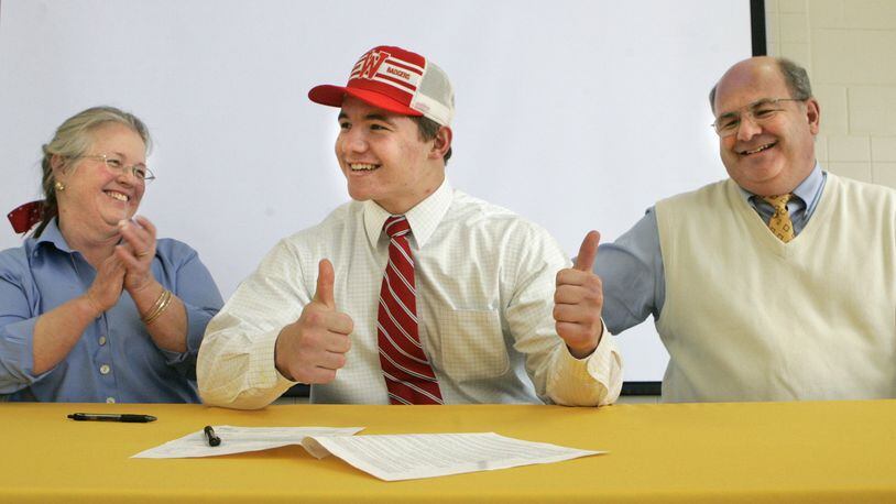 4 Feb 09. Chris Borland gives a thumbs-up after signing his National Letter of Intent to play football at the University of Wisconsin. Celebrating with him are his parents Zebbie (left) and Jeff Borland. The signing took place at Alter High School where Chris is a senior and played on the football team.