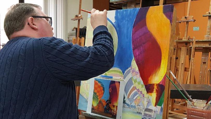 Duane Gordon, executive director of the Middletown Community Foundation, works on a collaborative painting that he and MAC painting instructor Karen Ng are contributing to the auction. CONTRIBUTED