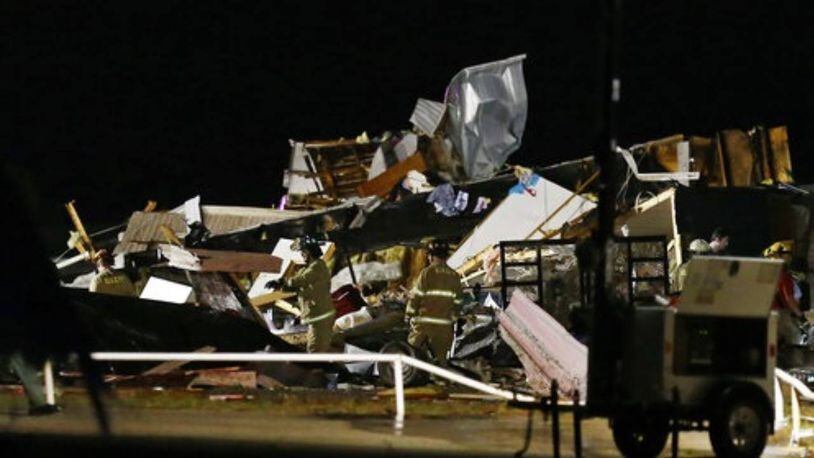 Emergency workers search through debris from a mobile home park in El Reno, Oklahoma, after a tornado hit the area.