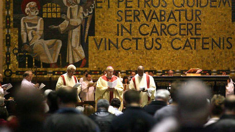 A Roman Catholic Mass is celebrated at St. Peter in Chains Cathedral in downtown Cincinnati to celebrate the election of Pope Francis in a 2013 file photo. Behind the altar, a mosaic in Latin says “Et Petrus quidem servabatur in carcere vinctus catenis,” which translates, “And Peter was kept in prison, bound in chains.” KAREEM ELGAZZAR / WCPO-TV