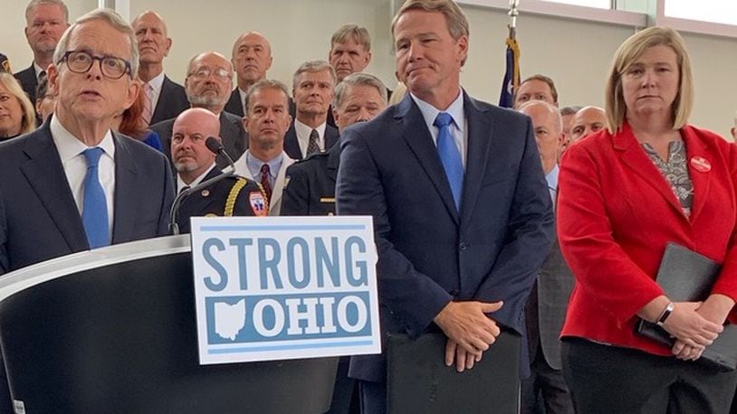 Gov. Mike DeWine announces his Strong Ohio gun bill plan Monday, Oct. 7 in Columbus. Lt. Gov. Jon Husted and Dayton Mayor Nan Whaley are to his right. Photo by Laura Bischoff