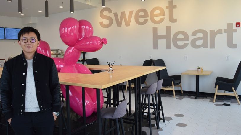 Jiawei Zhu is a partner in a new business, Sweet Heart, which is a Chinese tradition offering desserts in a place where people can gather for conversation. A central table wraps around a large balloon dog. CONTRIBUTED/BOB RATTERMAN