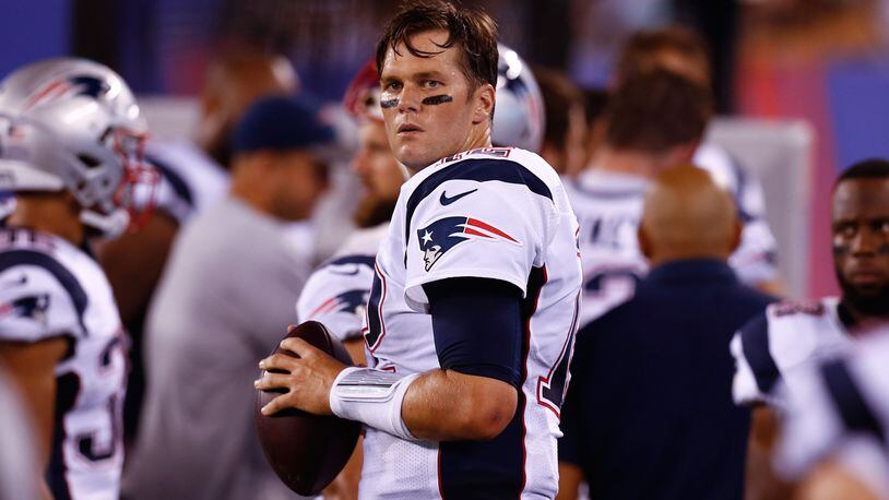 Tom Brady #12 of the New England Patriots warms up on the sidelines during their preseason game against the New York Giants at MetLife Stadium on September 1, 2016 in East Rutherford, New Jersey.