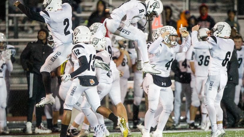 The Lakota East Thunderhawks show their joy after defeating host Mason 20-17 in a Division I, Region 4 playoff opener at Dwire Field in Mason on Friday night. NICK GRAHAM/STAFF