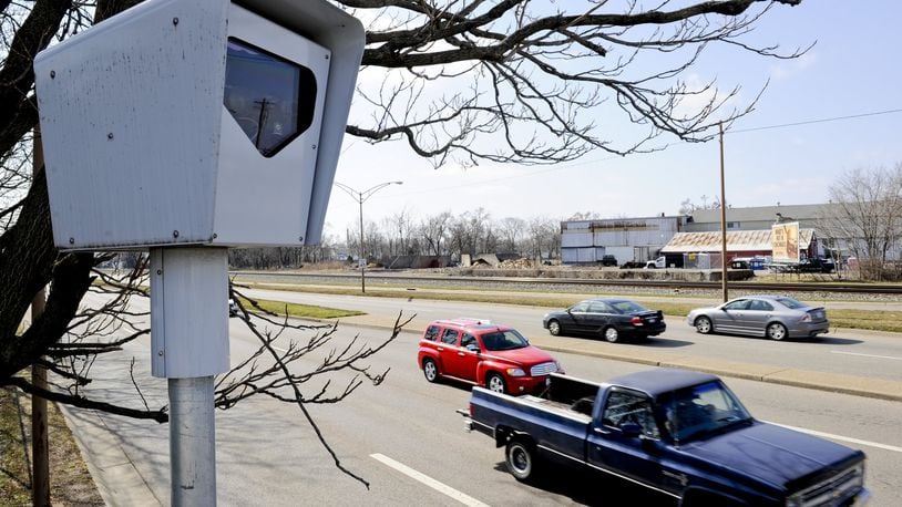 Vehicles pass by a red light camera in Middletown.