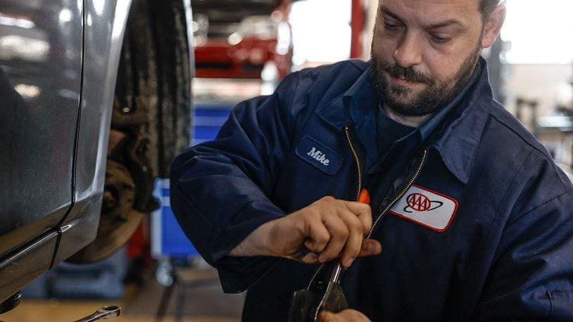 AAA auto mechanic Michael Mollett replaces brakes at the service center in Beavercreek Thursday, March 28, 2024. Auto repair is a good industry for workers to be in right now, said Dan Scroggins, vice president of personal lines insurance at AAA. Wages are up significantly over the last three years, and there is a ton of work, Scroggins said.  JIM NOELKER/STAFF