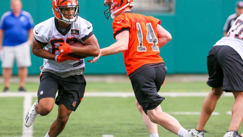 Bengals quarterback Andy Dalton (14) and wide receiver Tyler Boyd (83) participate in a team practice at Paul Brown Stadium, Tuesday, June 13, 2017. GREG LYNCH / STAFF