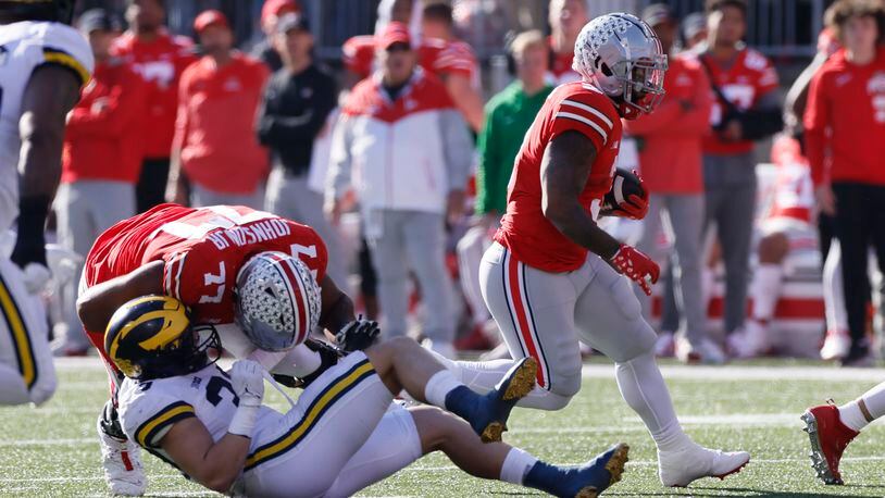 Ohio State running back Miyan Williams, right, follows a block by teammate Paris Johnson against Michigan during the first half of an NCAA college football game on Saturday, Nov. 26, 2022, in Columbus, Ohio. (AP Photo/Jay LaPrete)
