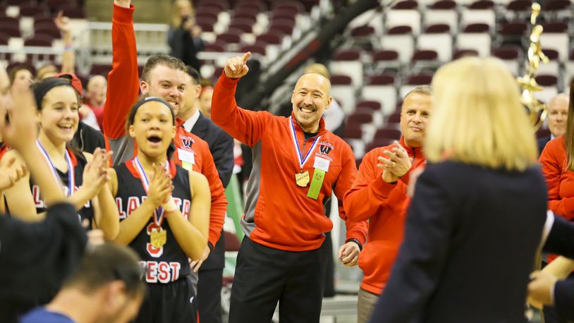 Lakota West coach Andy Fishman (center) celebrates with his team March 21, 2015, after the Firebirds beat Toledo Notre Dame Academy 44-38 to win the Division I state championship at the Schottenstein Center in Columbus. GREG LYNCH/STAFF