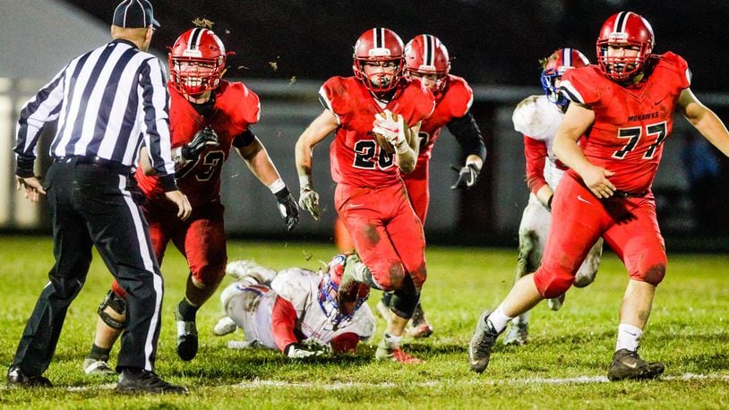 Madison’s Jake Phelps carries the ball against Portsmouth last Saturday night during a 26-0 victory in a Division V, Region 20 playoff game at Brandenburg Field in Madison Township.. NICK GRAHAM/STAFF