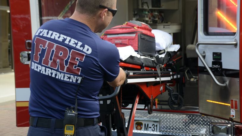 The city of Fairfield Fire Department will increase its minimum staffing sometime in the third quarter or later to 17 firefighters per shift. Pictured is Lt. Jamie Ruhl loading on July 25 a gurney into the new Medic 31 ambulance showcased at a Fairfield City Council meeting. MICHAEL D. PITMAN/STAFF