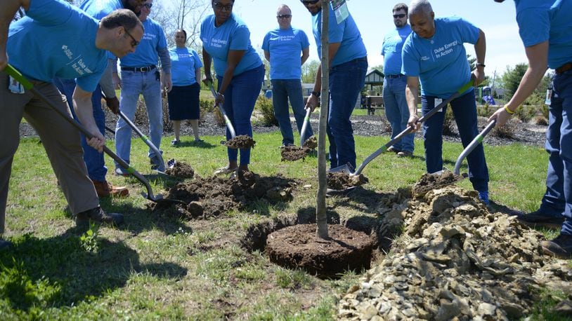 The city of Fairfield celebrates Earth Day on Monday, April 22, 2019, with a tree planting ceremony. The city planted two Wildfire Tupelo saplings, a black gum tree which can grow up to 40 feet with a canopy of 25 feet. Pictured are Duke Energy employees covering the sapling, which was donated by the energy company. MICHAEL D. PITMAN/STAFF