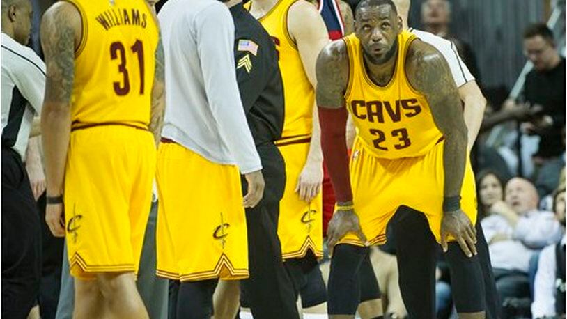 Cleveland Cavaliers' LeBron James (23) catches his breath after being hit in the groin, during the second half of an NBA basketball game against the Washington Wizards in Cleveland, Saturday, March 25, 2017. The Wizards won 127-115. (AP Photo/Phil Long)
